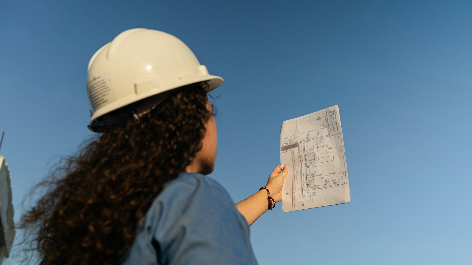 Engineer reviewing construction plans on site