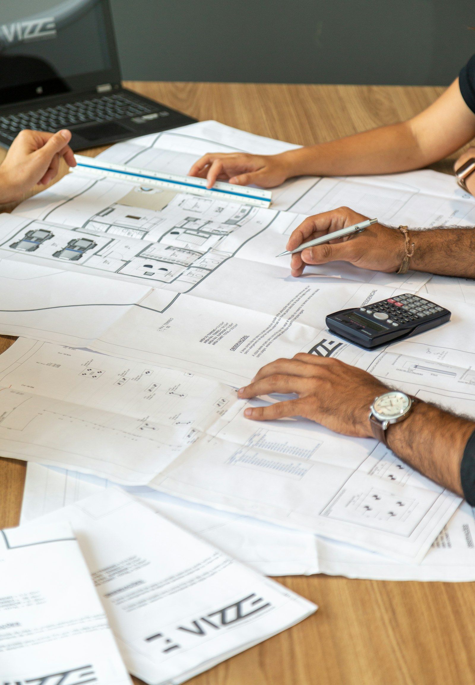 Construction drawings and a calculator on a quantity surveyor’s desk
